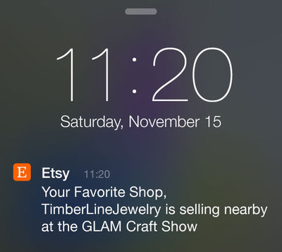 An Etsy push notification on a phone lock screen: Your Favorite Shop, TimberLineJewelry is selling nearby at the GLAM Craft Show.